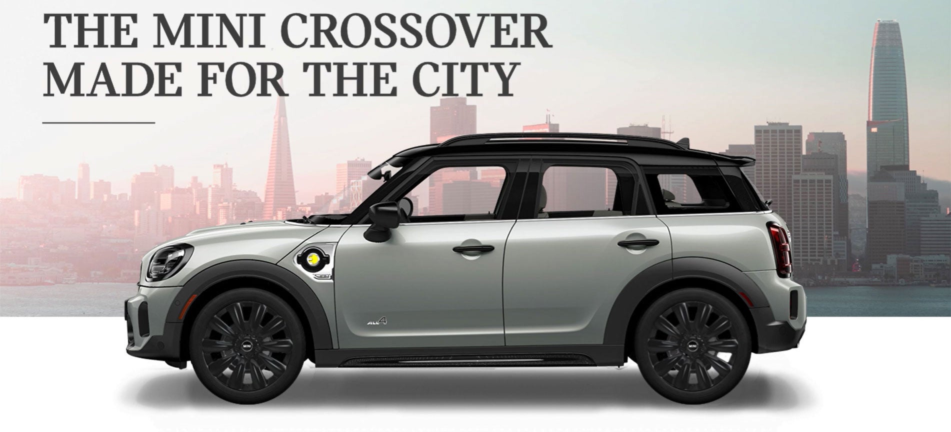 The MINI Cooper SE Countryman PHEV parked in front of a city scape. Flow MINI in Winston-Salem NC