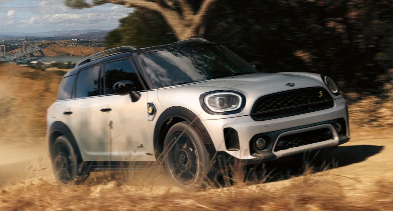 The MINI Cooper SE Countryman PHEV driving on dirt terrain. Flow MINI in Winston-Salem NC