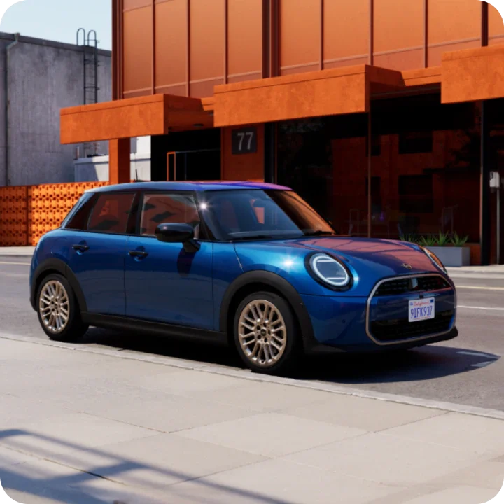 The MINI Cooper S 4 Door parked in front of an orange building.