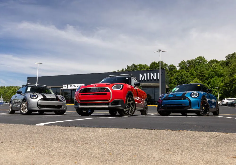 Three used MINI cars parked in front of the Flow MINI dealership in Winston-Salem